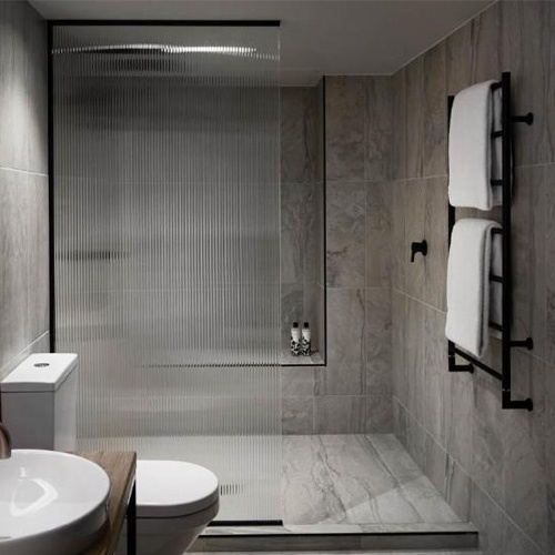 Fluted glass shower screen in hotel bathroom