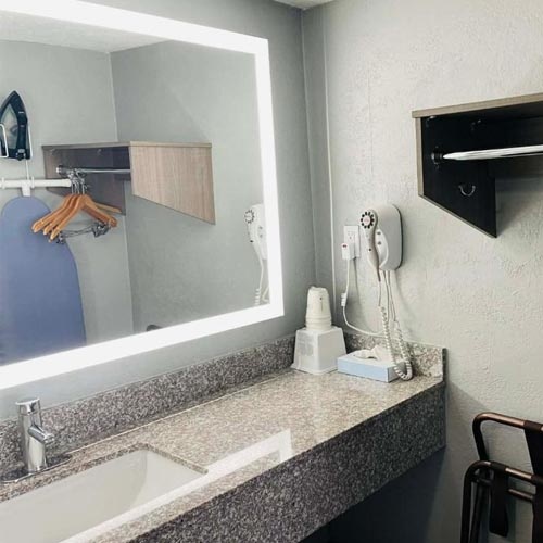 Pink granite bathroom vanity top with backspashes and front apron for Travelodge motel