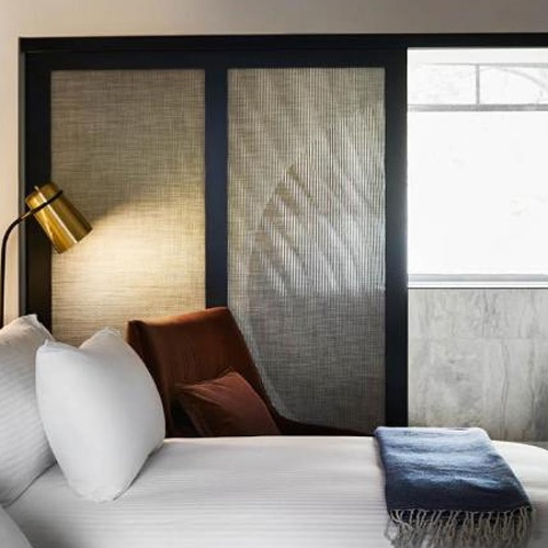 Sliding door with fabric laminated glass panel