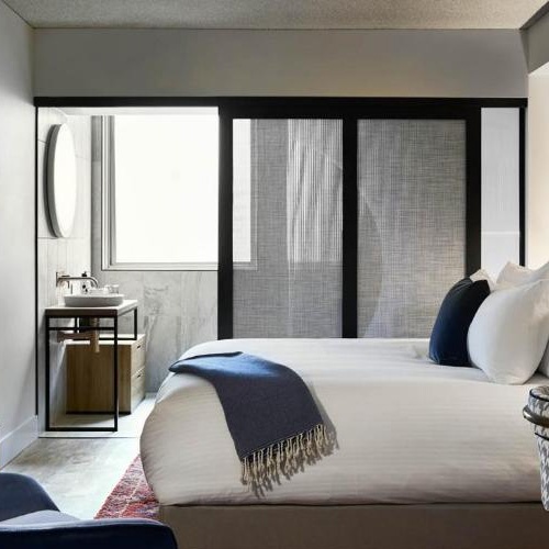 Sliding door with fabric laminated glass panel