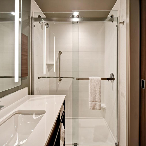Frameless bypass glass shower door in Hilton Garden Inn Bathroom