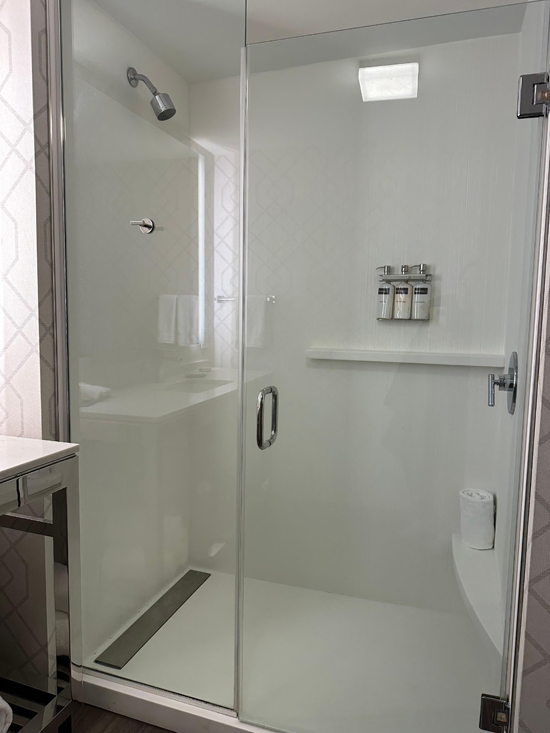 Inline glass shower door swing