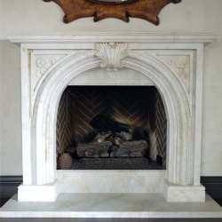 A custom English stone fireplace mantel