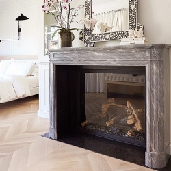 A dark marble mantel injects a grace note