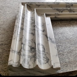 Fireplace mantel with scolloped jamb in honed arabescato corchia marble