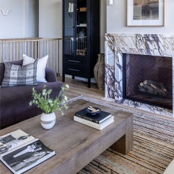 Fireplace wrapped in Abrabescato Viola marble