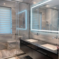 Glass shower door and LED backlit mirror for hotel bathroom in Dubai