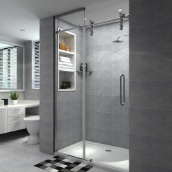 Glass shower door with floor to ceiling fixed glass panel