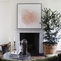 Marble fireplace mantel and wall artwork