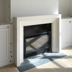 Residence modern fireplace surround in honed turkish limestone