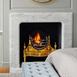 Slim profile marble fireplace surround in bedroom