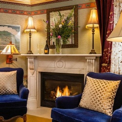 Traditional white marble fireplace mantel in village inn guestroom