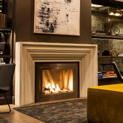 limestone fireplace mantel in the lounge of studio and apartment